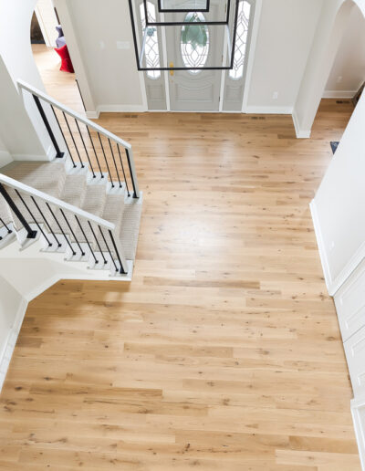 A photo of an entryway featuring 4-inch white oak natural finish floors.
