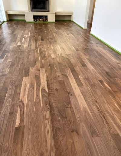 Refinished walnut hardwood flooring with a mixture of light and dark wood colors and a variety of grains.